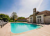 Thumbnail 21 of 61 - A large swimming pool in front of a house with a stone tower.
