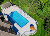 Thumbnail 22 of 61 - A large swimming pool surrounded by a fence and a small building.