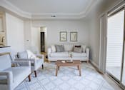 Thumbnail 28 of 61 - A living room with a grey couch, a white couch, and a wooden coffee table.