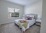 Thumbnail 30 of 61 - A bedroom with a large bed and a window with blinds.