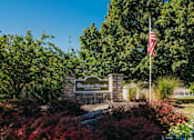 Thumbnail 40 of 61 - A sign that says Blendon Woods is in front of a flag.