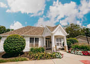 Thumbnail 45 of 61 - A white house with a brown roof and a small front porch.