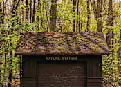 Thumbnail 58 of 61 - A small brown building with a Nature Station sign on it.
