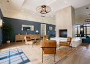 Thumbnail 2 of 36 - A living room with a blue rug and brown chairs.