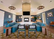 Thumbnail 5 of 36 - A living room with a fireplace and a television.