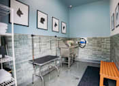 Thumbnail 13 of 36 - A room with a bench, a table, and a sink.