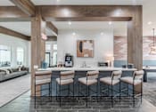 Thumbnail 6 of 21 - A kitchen with a bar area and a dining table.