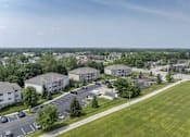 Thumbnail 1 of 42 - A view of a residential area with apartment buildings and a parking lot.