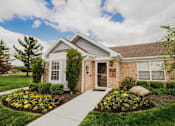 Thumbnail 5 of 42 - A house with a front yard and a walkway leading to the front door.