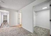 Thumbnail 22 of 42 - A spacious room with a carpeted floor and white walls.