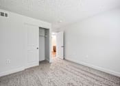 Thumbnail 24 of 42 - A room with a carpeted floor and two doors.