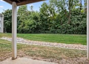 Thumbnail 27 of 42 - A grassy area with a gravel path and a wooden post.