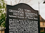 Thumbnail 32 of 42 - A sign for the Old Town Greenwood Residential Historic District stands in front of a tree.
