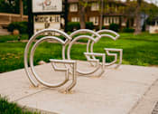 Thumbnail 33 of 42 - A metal sculpture of the letters G, F, and C is displayed on a sidewalk.