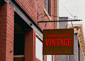 Thumbnail 37 of 42 - A red brick building with a sign that says Main Street Vintage.