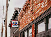 Thumbnail 39 of 42 - A brick building with a sign that says "Brewpub".