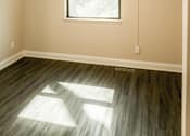 Thumbnail 23 of 27 - A room with a ceiling fan and a window letting in sunlight.