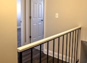 Thumbnail 21 of 27 - A white door is at the end of a hallway.