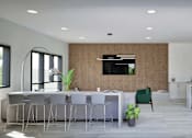 Thumbnail 13 of 17 - A modern kitchen with a dining table and chairs.