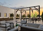 Thumbnail 6 of 17 - A patio with chairs and tables is set up for an outdoor gathering.