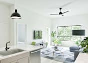 Thumbnail 8 of 17 - A modern kitchen with a white countertop and a grey rug.
