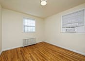Thumbnail 9 of 15 - A room with a window and a radiator on the floor.