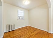 Thumbnail 10 of 15 - A room with a window and a radiator on the floor.
