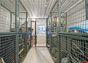Thumbnail 18 of 18 - A long hallway with a metal fence on the left and a blue object on the right.