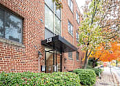 Thumbnail 2 of 18 - A brick building with the number 320 on it.