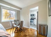 Thumbnail 8 of 18 - A kitchen with a table and chairs is visible from the living room.
