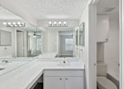 Thumbnail 18 of 42 - A white bathroom with a vanity and a toilet.