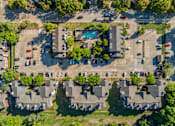 Thumbnail 35 of 42 - An aerial view of a residential area with houses and cars.