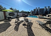 Thumbnail 38 of 42 - A pool area with chairs and a sign that says Fairway.