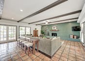 Thumbnail 17 of 18 - A kitchen with tile flooring and a large island.