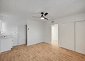 Thumbnail 61 of 71 - A room with a ceiling fan and wooden flooring.