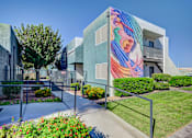 Thumbnail 70 of 71 - A modern building with a colorful mural on the side.