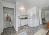 Thumbnail 6 of 28 - A white kitchen with a washing machine in the corner.