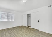 Thumbnail 10 of 56 - A room with a white door and a window with blinds.