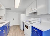 Thumbnail 3 of 56 - A kitchen with white cabinets and blue drawers.