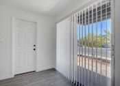 Thumbnail 7 of 56 - A white door with a black handle is in a room with a window covered with white blinds.