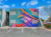 Thumbnail 37 of 56 - A colorful mural of a bird painted on a building.