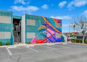 Thumbnail 42 of 56 - A colorful mural of a flamingo is painted on the side of a building.