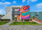 Thumbnail 47 of 56 - A colorful mural on a building in a residential area.