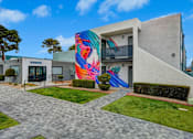 Thumbnail 46 of 56 - A modern building with a colorful mural on the side.