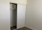 Thumbnail 34 of 56 - A room with a carpeted floor and a white door.