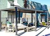 Thumbnail 52 of 56 - A poolside lounge area with a canopy and seating.
