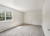 Thumbnail 15 of 15 - A room with a carpeted floor and a window with blinds.