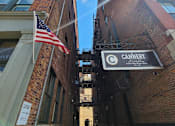 Thumbnail 1 of 19 - A narrow alley with a cannery sign on the right.