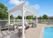 Thumbnail 9 of 15 - A white pergola is over a patio with a pool.