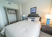 Thumbnail 13 of 15 - A bedroom with a large bed and two lamps.